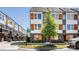 Exterior shot of modern townhomes with brick and siding, complemented by landscaped greenery and street signage at 2123 Bryant Park Dr, Charlotte, NC 28208