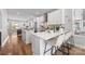 Well-lit kitchen with stainless steel appliances, white cabinetry, and a marble-topped island with seating at 2123 Bryant Park Dr, Charlotte, NC 28208