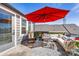 Inviting patio area featuring a bright red umbrella and comfortable outdoor seating arrangement at 2123 Bryant Park Dr, Charlotte, NC 28208