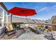 Stylish patio offers comfortable seating with an overhead red umbrella and views of nearby rooftops at 2123 Bryant Park Dr, Charlotte, NC 28208