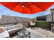 Outdoor rooftop terrace with lounge seating, an orange umbrella and a city view at 2123 Bryant Park Dr, Charlotte, NC 28208