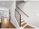 Bright staircase featuring wood treads, modern railings, and hardwood floors leading to the upper level of the home at 2123 Bryant Park Dr, Charlotte, NC 28208