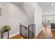 Second story staircase landing featuring hardwood floors, modern railing and neutral walls with access to living area at 2123 Bryant Park Dr, Charlotte, NC 28208
