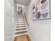 Interior staircase featuring hardwood treads, white risers, a wooden banister and a safety gate at 2123 Bryant Park Dr, Charlotte, NC 28208