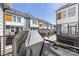 View of adjacent townhomes from balcony with covered grill, black metal railing, and exterior gray color schemes at 2123 Bryant Park Dr, Charlotte, NC 28208