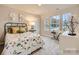 ' bedroom featuring two large windows, a dinosaur-themed bed, stylish side tables, and a decorative chair at 2159 Trollinger Dr, Catawba, NC 28609