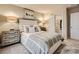 Beautiful bedroom featuring a soft, upholstered bed, side tables, lamps, and an open closet with hanging storage at 2159 Trollinger Dr, Catawba, NC 28609