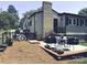 Well-maintained backyard features a lovely patio with ample seating and a classic brick chimney at 217 Hickory Dr, Mooresville, NC 28115