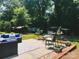 Lush backyard featuring an outdoor seating area, complemented by mature trees and landscaping at 217 Hickory Dr, Mooresville, NC 28115
