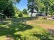 Spacious backyard with mature trees, offering privacy and a serene outdoor setting at 217 Hickory Dr, Mooresville, NC 28115