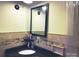 Bathroom with a dark granite countertop, decorative mirror, and ample lighting at 217 Hickory Dr, Mooresville, NC 28115