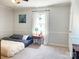 Cozy bedroom with plush carpeting, side table, and ample natural light at 217 Hickory Dr, Mooresville, NC 28115