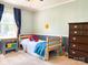 Bright bedroom with blue accents, comfortable bed, and spacious dresser at 217 Hickory Dr, Mooresville, NC 28115