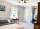 Comfortable bedroom with ceiling fan, carpeting, side table, and soft natural light at 217 Hickory Dr, Mooresville, NC 28115