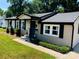 Charming single-story home featuring a brick facade, manicured lawn, and inviting front porch at 217 Hickory Dr, Mooresville, NC 28115