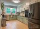 Well-lit kitchen with stainless steel appliances, wood floor and abundant countertop space at 217 Hickory Dr, Mooresville, NC 28115