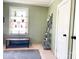 Bright living room with shelving unit, large window, and neutral wall and carpet colors at 217 Hickory Dr, Mooresville, NC 28115