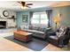 Cozy living room with a fireplace, large sofa, leather armchair, and neutral tones at 217 Hickory Dr, Mooresville, NC 28115