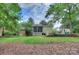 Beautiful backyard view featuring lush greenery and screened porch, creating a private outdoor space at 2235 Ramblewood Ln, Charlotte, NC 28210