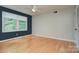 Bright bedroom showcasing hardwood floors, a ceiling fan, and large windows that allow for plenty of natural light at 2235 Ramblewood Ln, Charlotte, NC 28210