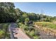 Scenic view of a community park featuring a walking path, a river, and lush greenery, offering a serene escape at 2235 Ramblewood Ln, Charlotte, NC 28210