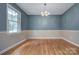 Bright dining area featuring classic hardwood floors and modern lighting fixture at 2235 Ramblewood Ln, Charlotte, NC 28210
