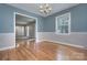Inviting dining room with hardwood floors, chair rail molding, and decorative lighting at 2235 Ramblewood Ln, Charlotte, NC 28210
