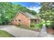 Charming brick home featuring a well-maintained yard, a driveway, and mature trees in a serene neighborhood setting at 2235 Ramblewood Ln, Charlotte, NC 28210