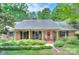 Charming brick home with black shutters and a well-manicured front yard at 2235 Ramblewood Ln, Charlotte, NC 28210