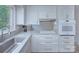 Updated kitchen featuring granite countertops, white cabinets, and modern fixtures at 2235 Ramblewood Ln, Charlotte, NC 28210