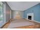 Spacious living room with hardwood floors, fireplace, and ample natural light at 2235 Ramblewood Ln, Charlotte, NC 28210