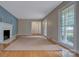 Bright living room with hardwood floors, a fireplace, and large windows at 2235 Ramblewood Ln, Charlotte, NC 28210