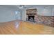 Inviting living room with beautiful hardwood floors and a classic brick fireplace at 2235 Ramblewood Ln, Charlotte, NC 28210