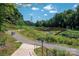 Scenic walking trail with a bridge crossing a creek, surrounded by lush greenery, perfect for outdoor recreation at 2235 Ramblewood Ln, Charlotte, NC 28210