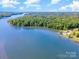 Aerial view of waterfront community featuring lush tree coverage and calm river at 235 River Loop Rd, Belmont, NC 28012