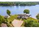 Aerial view of home with swimming pool, lake access, and basketball court at 235 River Loop Rd, Belmont, NC 28012