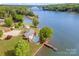Aerial view of home with pool, pier, and waterfront access at 235 River Loop Rd, Belmont, NC 28012