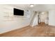 Finished basement with a TV, refrigerator, and a staircase to the upper level at 235 River Loop Rd, Belmont, NC 28012