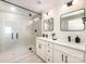 Modern bathroom with a large walk-in shower with black hardware and dual vanity at 235 River Loop Rd, Belmont, NC 28012