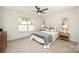 Bedroom with a plush bed, modern light fixtures, and a large window for natural light at 235 River Loop Rd, Belmont, NC 28012