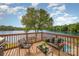 Relax on the deck with beautiful lake views and comfortable seating; ideal for outdoor living at 235 River Loop Rd, Belmont, NC 28012