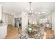 Bright dining area with a glass table, modern chandelier, and open flow into the kitchen and living room at 235 River Loop Rd, Belmont, NC 28012