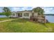 Well-maintained home with a waterfront view, grassy lawn, and a charming wooden deck at 235 River Loop Rd, Belmont, NC 28012