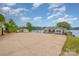 Exterior view of the waterfront home with driveway and lake in the background at 235 River Loop Rd, Belmont, NC 28012