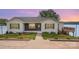 Charming single-story home with a well-manicured lawn, beautiful landscaping, and a lakeside view at 235 River Loop Rd, Belmont, NC 28012