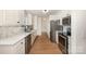 Kitchen with stainless steel appliances, white cabinets, quartz countertops, and an open layout at 235 River Loop Rd, Belmont, NC 28012