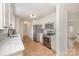 Bright kitchen with white cabinets, stainless steel appliances, quartz countertops, and an open layout at 235 River Loop Rd, Belmont, NC 28012