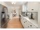 Kitchen with stainless steel appliances, white cabinets, quartz countertops, and open flow into the dining room at 235 River Loop Rd, Belmont, NC 28012