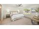 Bright main bedroom featuring a large window, neutral carpet, and a padded headboard at 235 River Loop Rd, Belmont, NC 28012