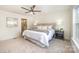 Main bedroom with neutral carpet, padded headboard, and ensuite bathroom at 235 River Loop Rd, Belmont, NC 28012
